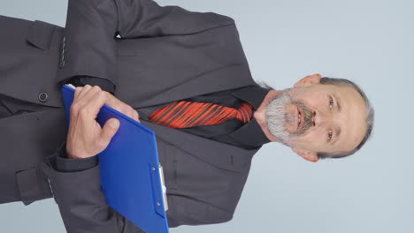 Vertical-video-of-Old-businessman-trying-to-memorize-his-presentation.